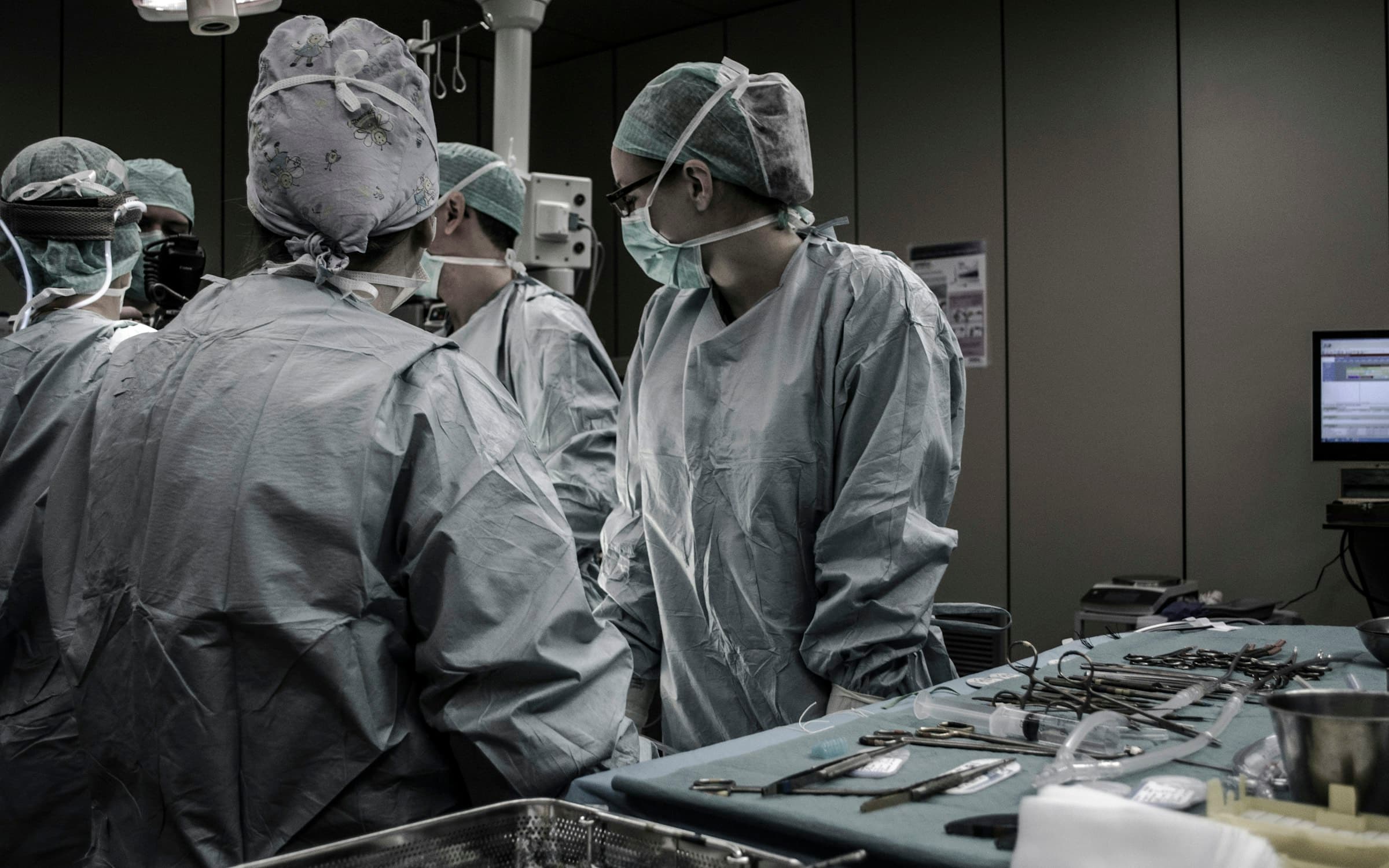 Surgeons working under operating-theatre lights
